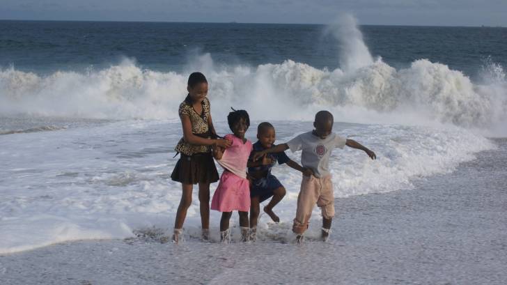 happy children splashing in the ocean