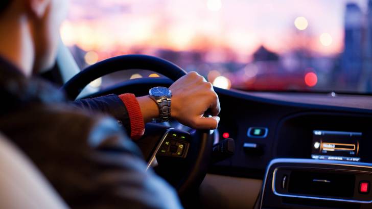 man driving a car