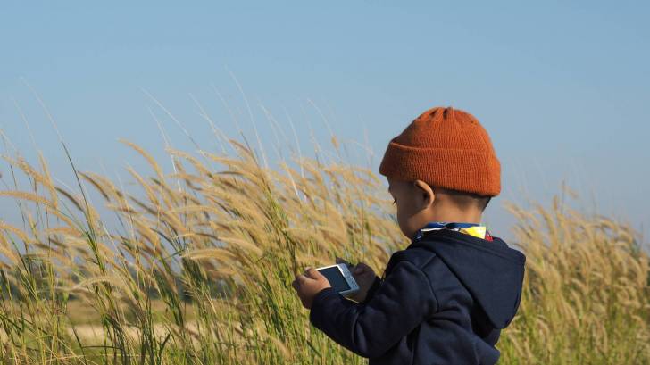 young boy in a field healthy and happy