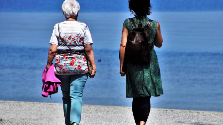 women walking on the beach talking