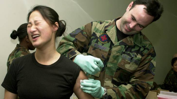 us military service woman getting a vaccination