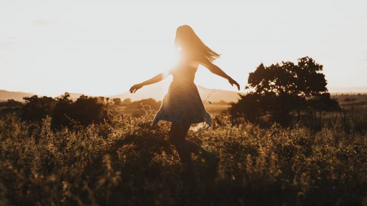 young girl happy in a field