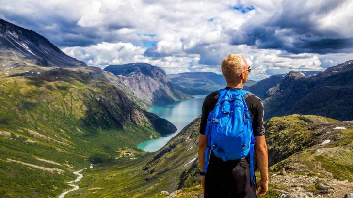 norway mountains with a hiker looking into the sky