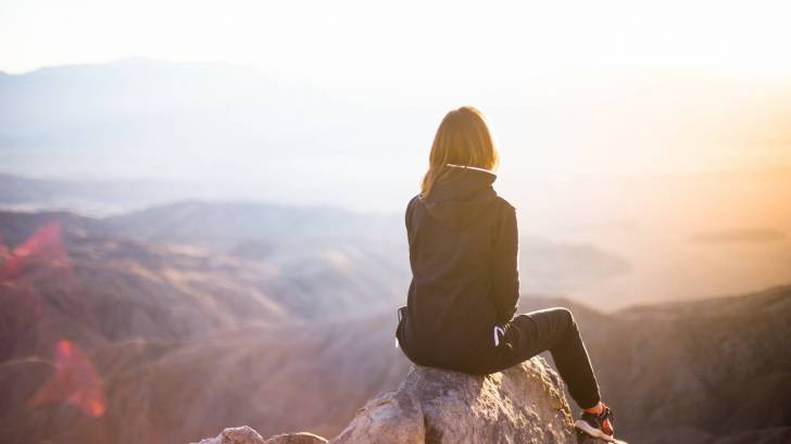 woman traveler on the tip of mountain