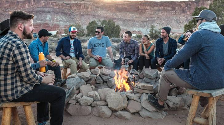 people around a camp fire celebrating