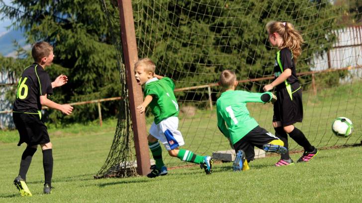 children playing soccer happy