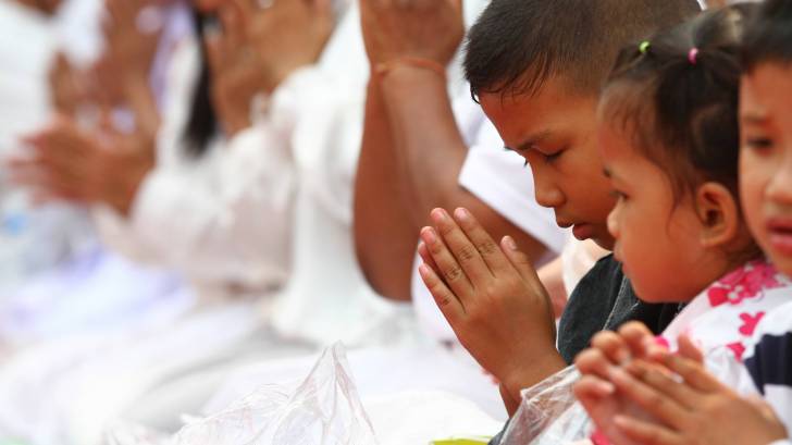 buddhist children in Laos praying