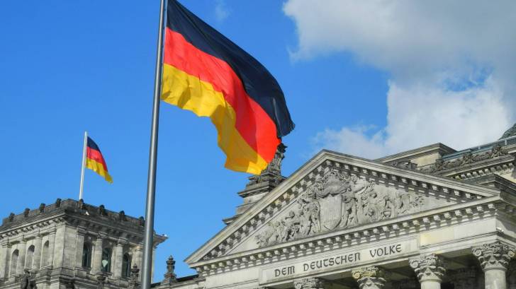 german flag flying over a court building