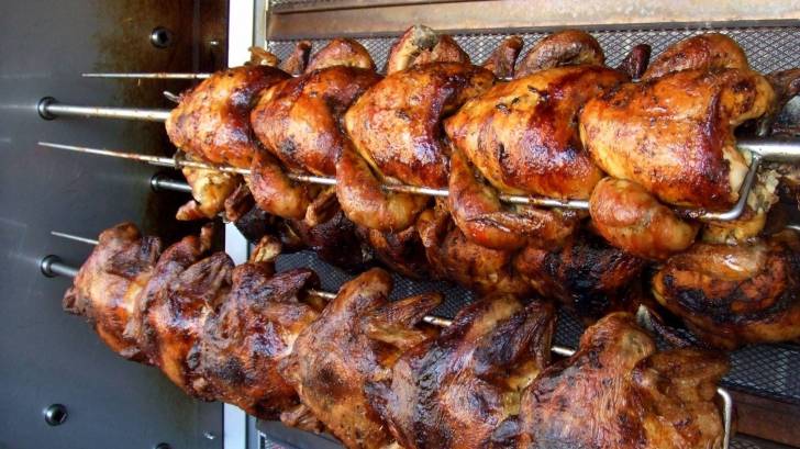 chickens being cooked on a rotisserie