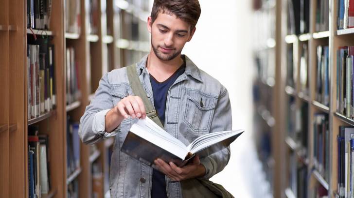 male student in the college library