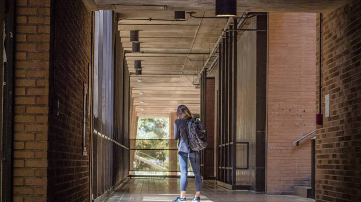 student walking to the UCLA library