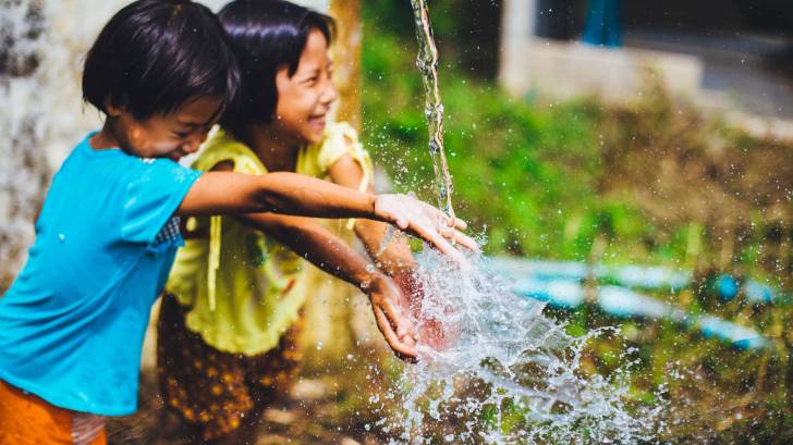 children playing in the water fountain