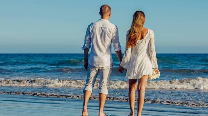 young couple looking at the surf