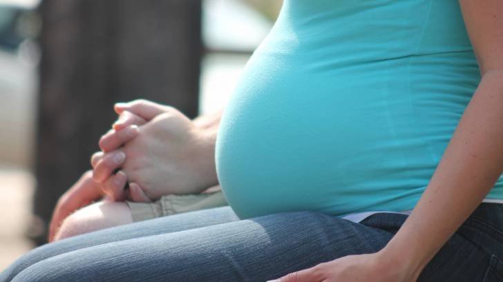 pregnant mom holding hands with husband