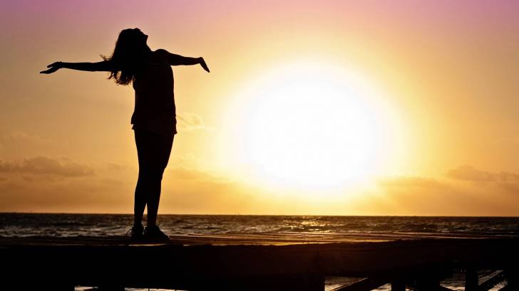 woman celebrating the sunrise