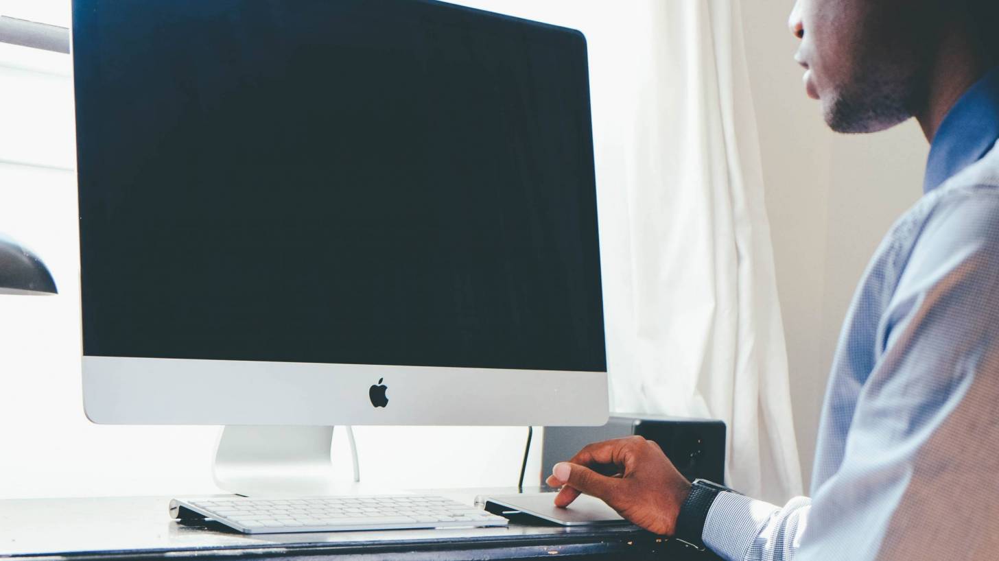 black doctor working on computer