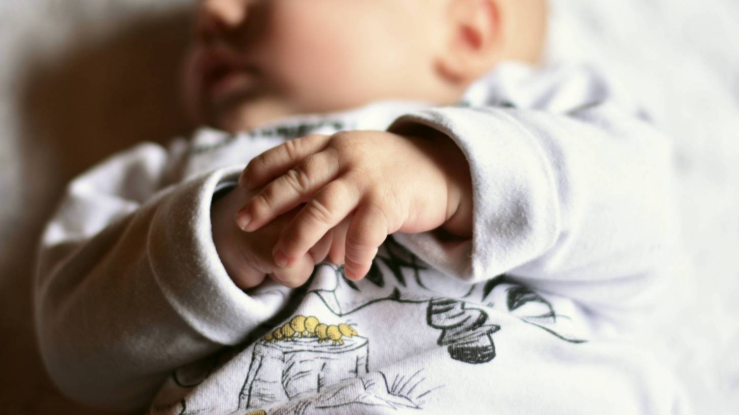 baby sleeping with chubby fingers