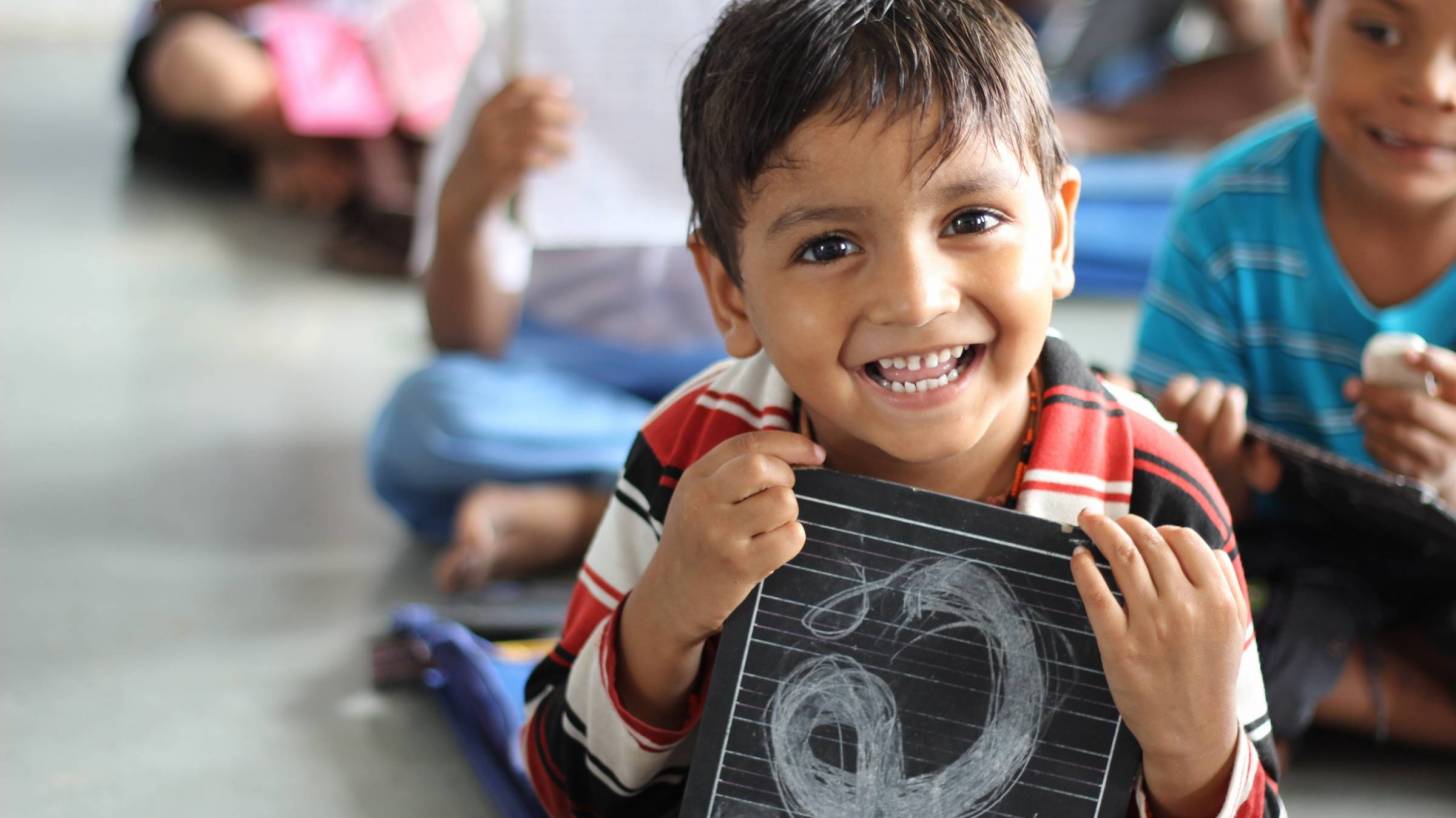 school children smiling in classroom