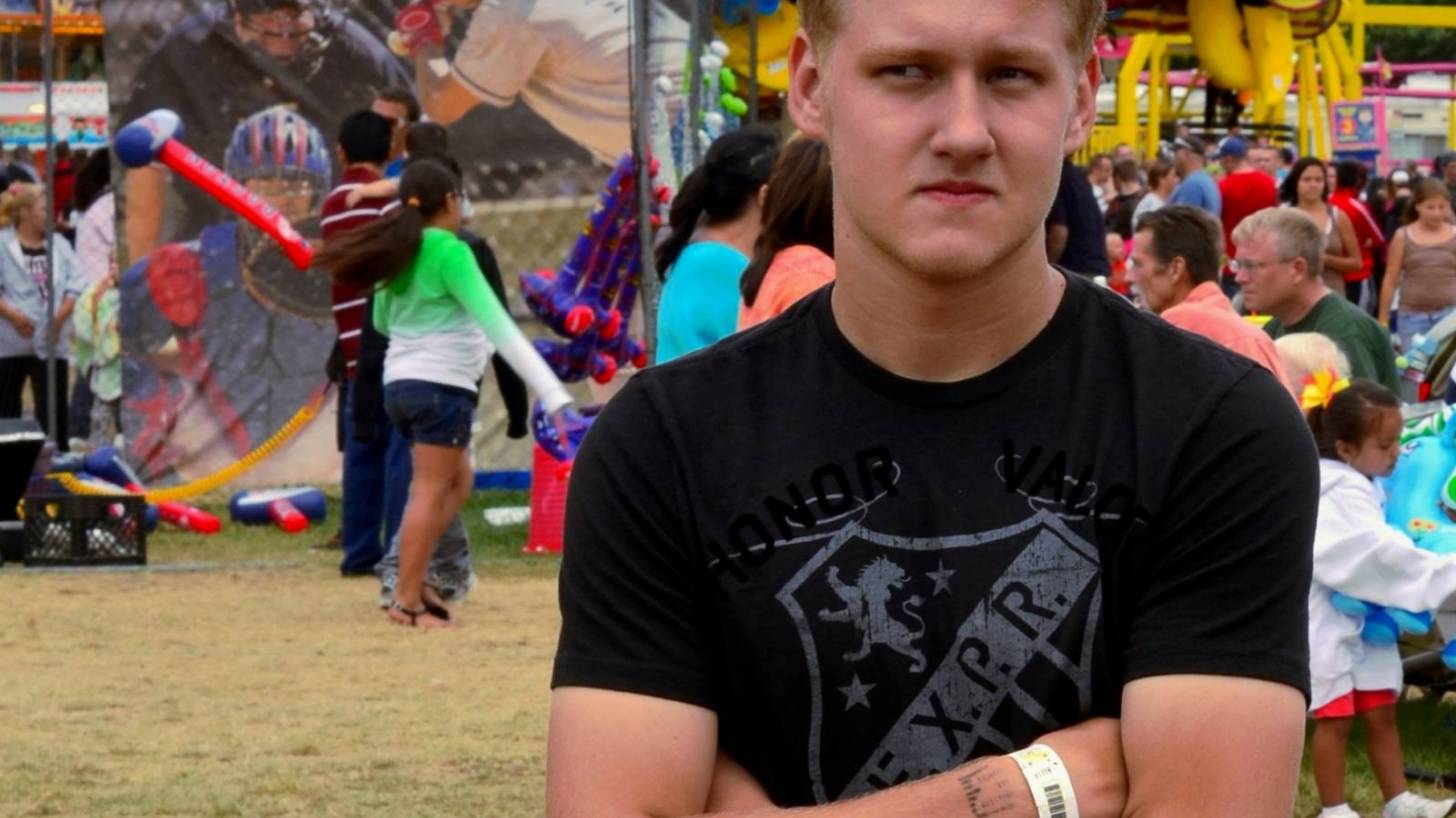 young man standing with arms crossed