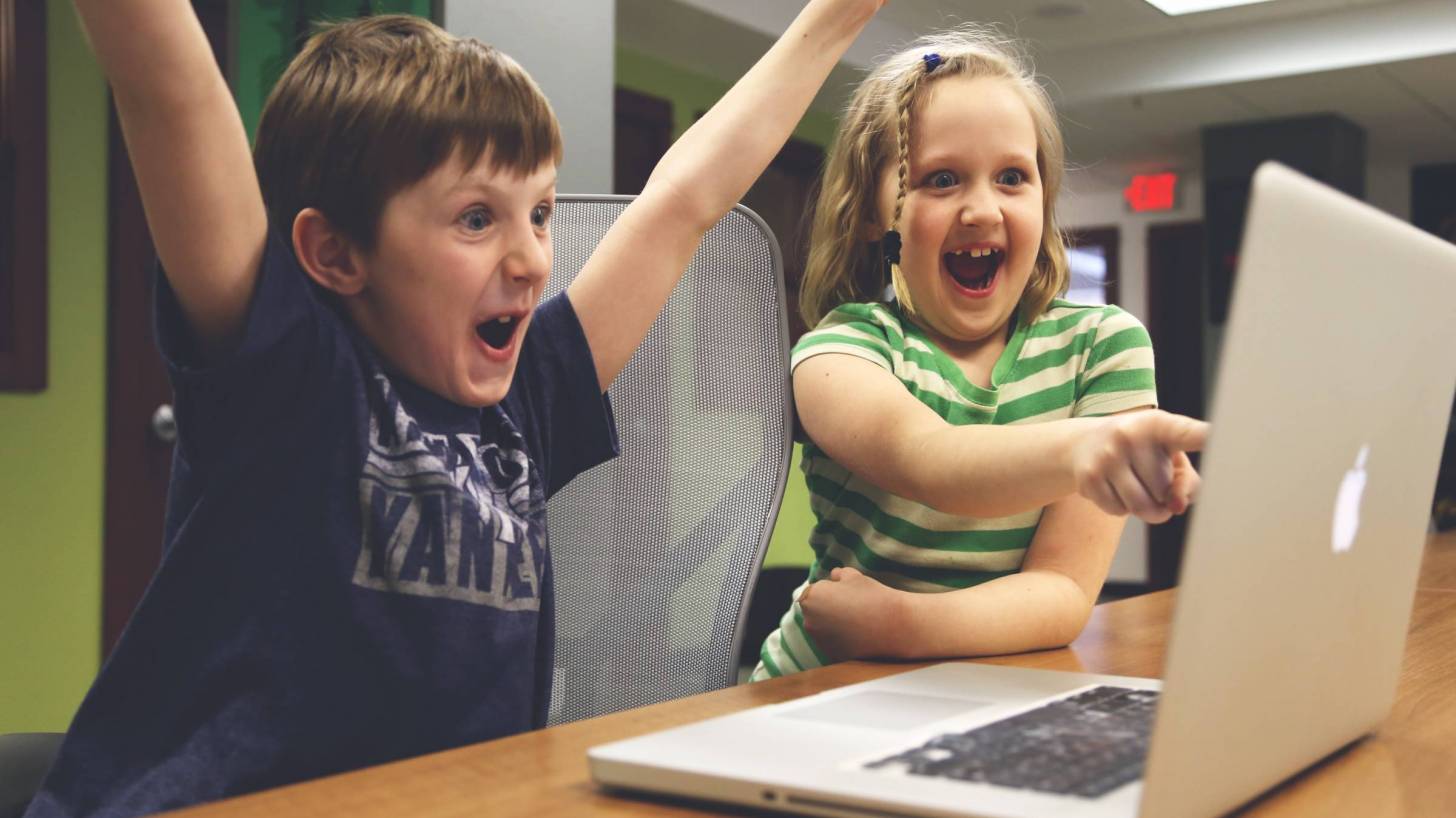 kids looking at a video on a computer screen