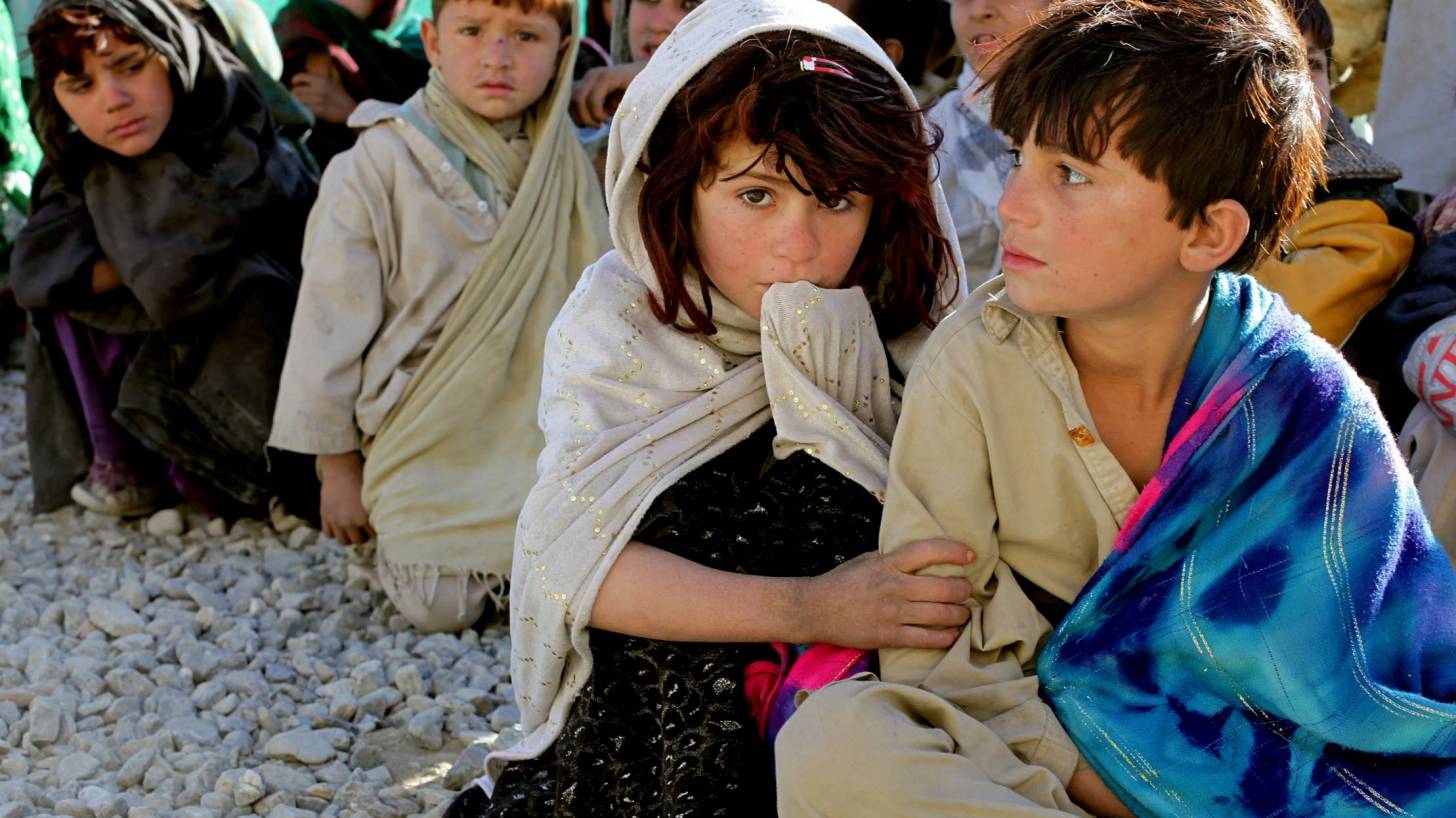 Afghan children sitting in a line 