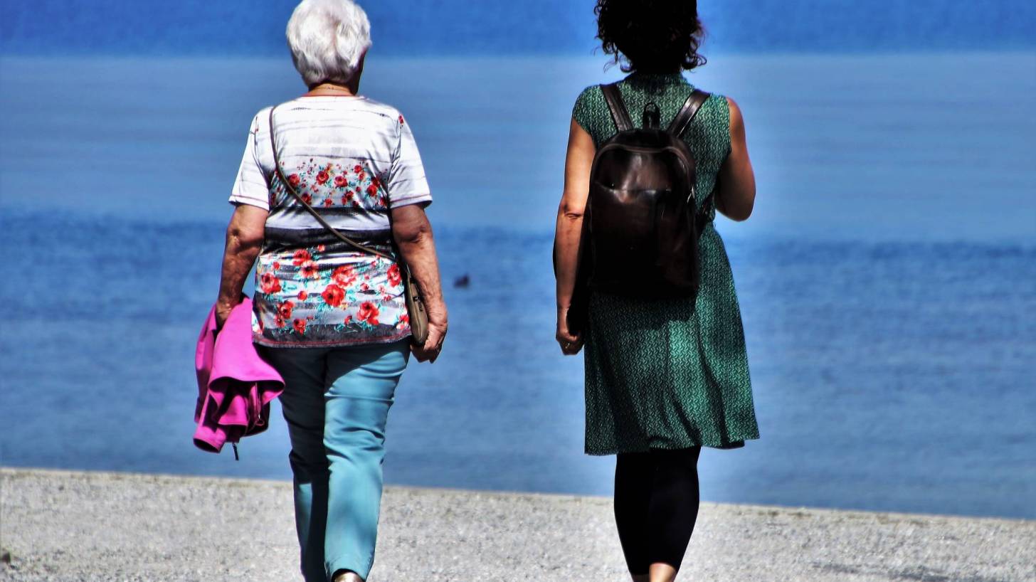 women walking on the beach talking