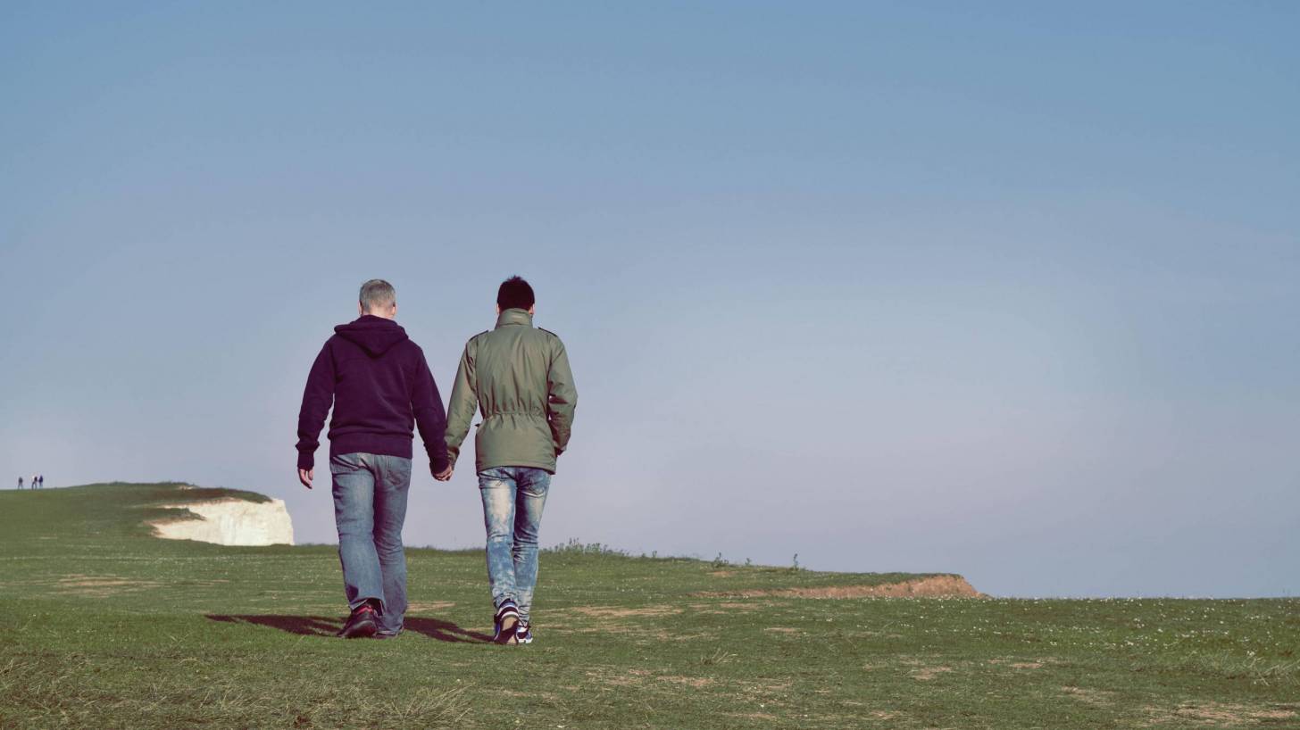 people walking along the edge of a cliff