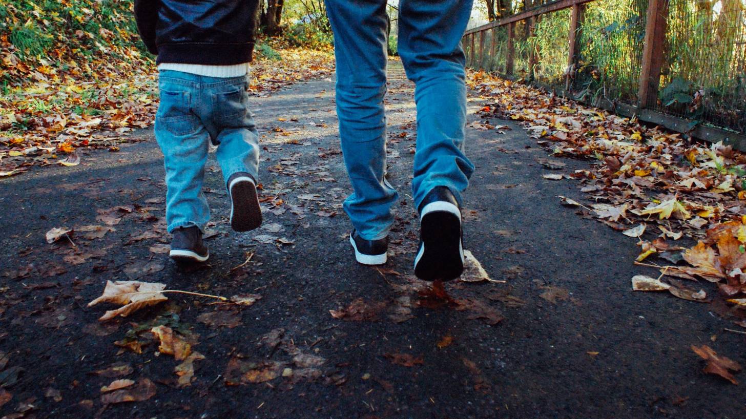 dad and son walking along a trail