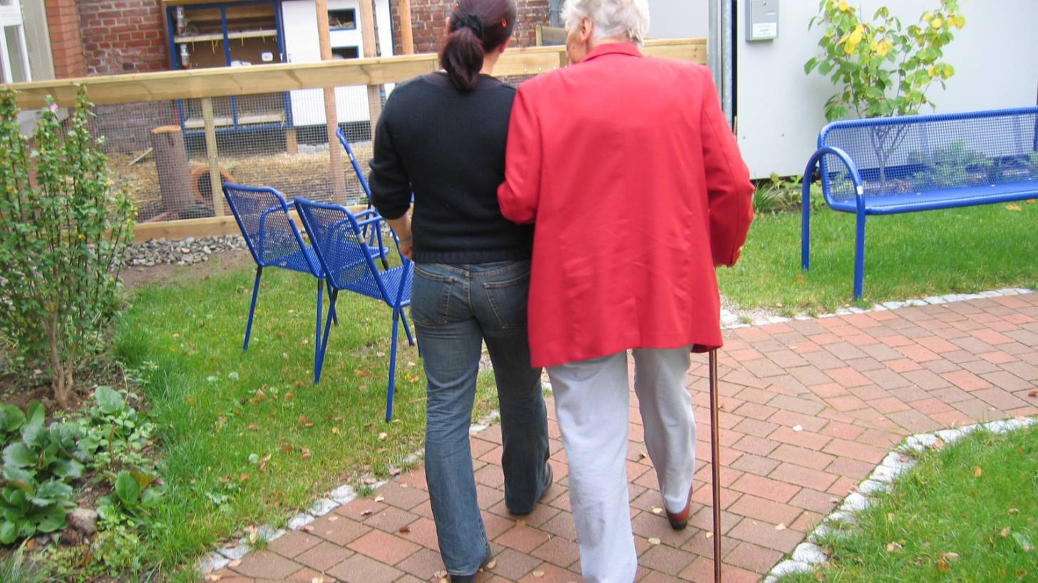 women walking arm in arm