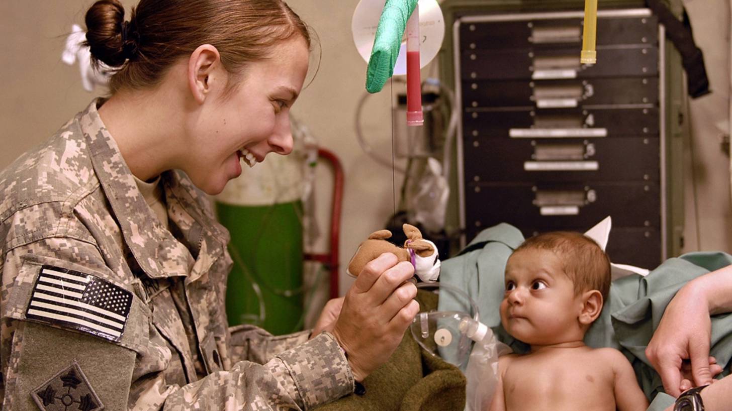 medical doctor in the field taking care  of infant