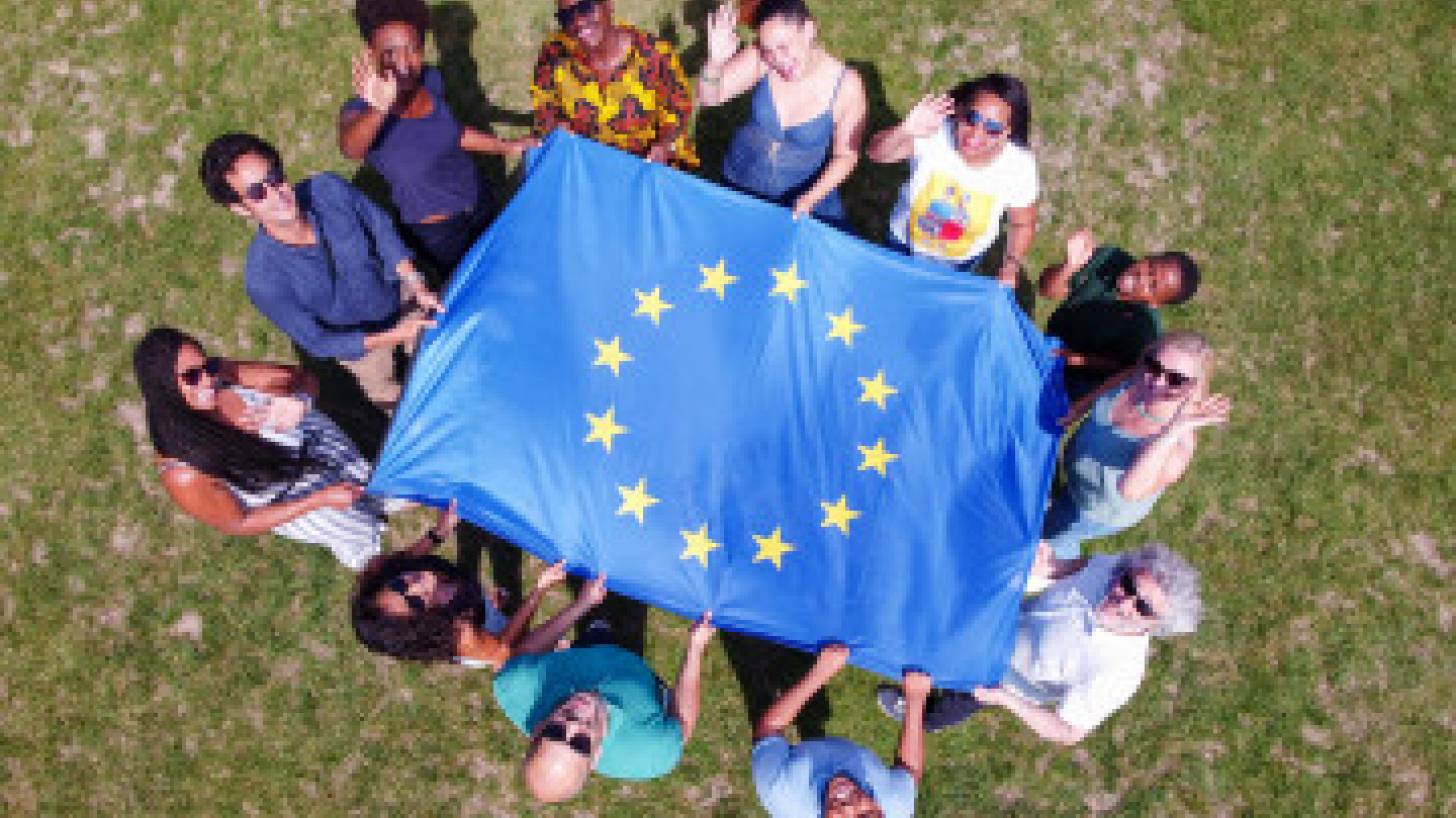 young people holding a flag