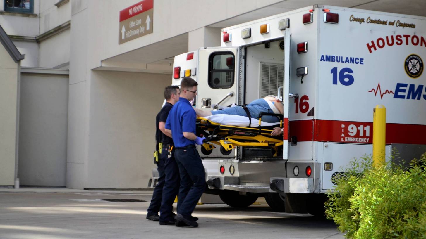 houston first responder with a patient going into ambulance