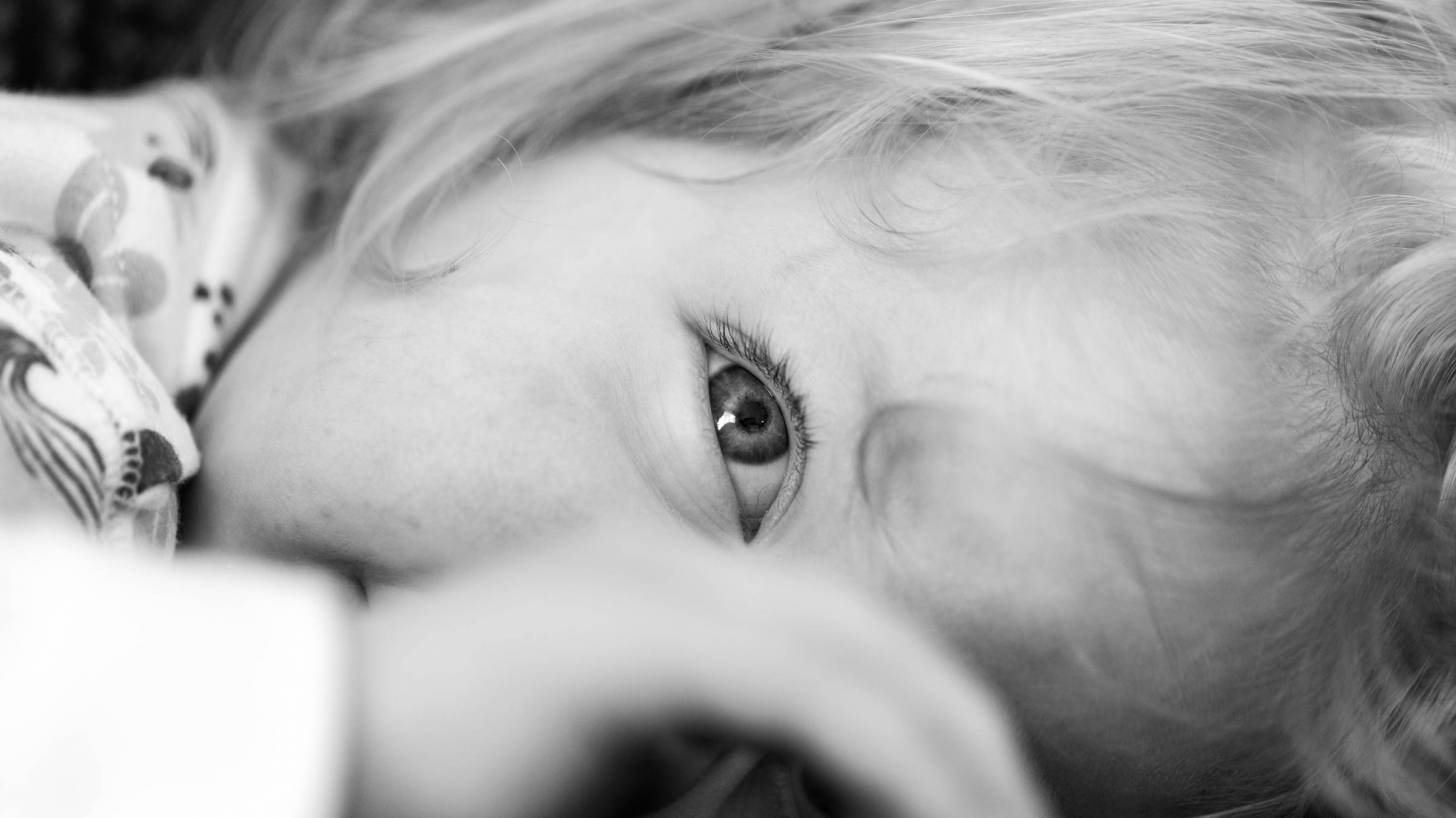 young girl looking through her hand