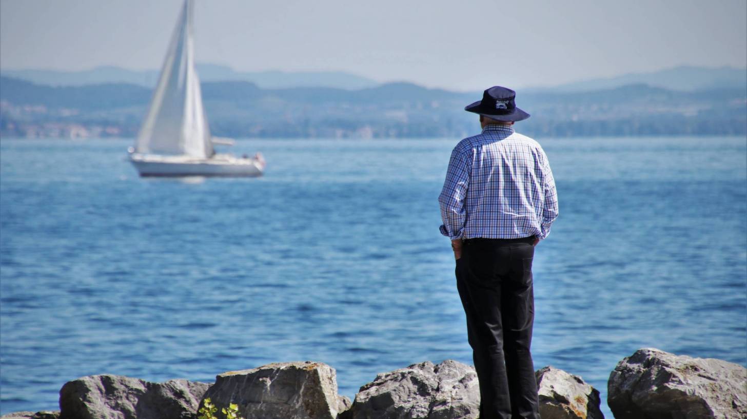 old man looking at the lake