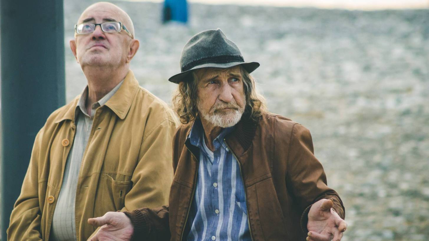 two older men sitting on a bench