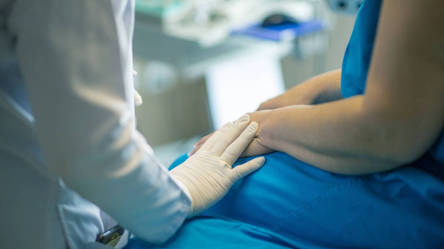 woman being talked to by a doctor in a clincial trial