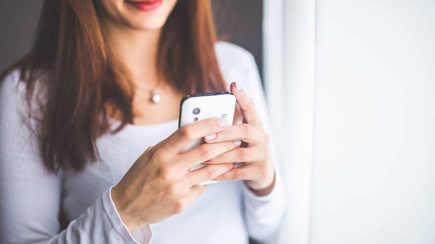 woman looking at her smart phone app