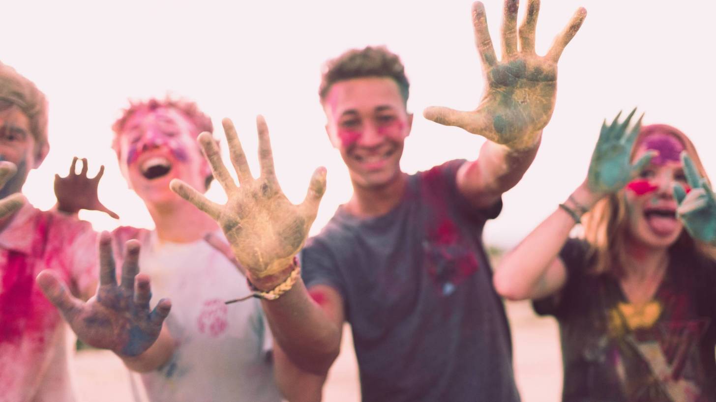 teens having fun with color paints