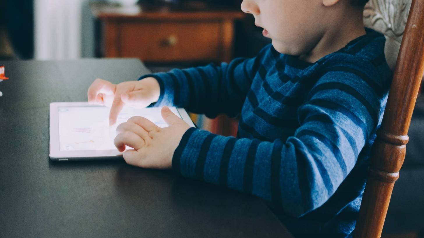 young child testing on an ipad