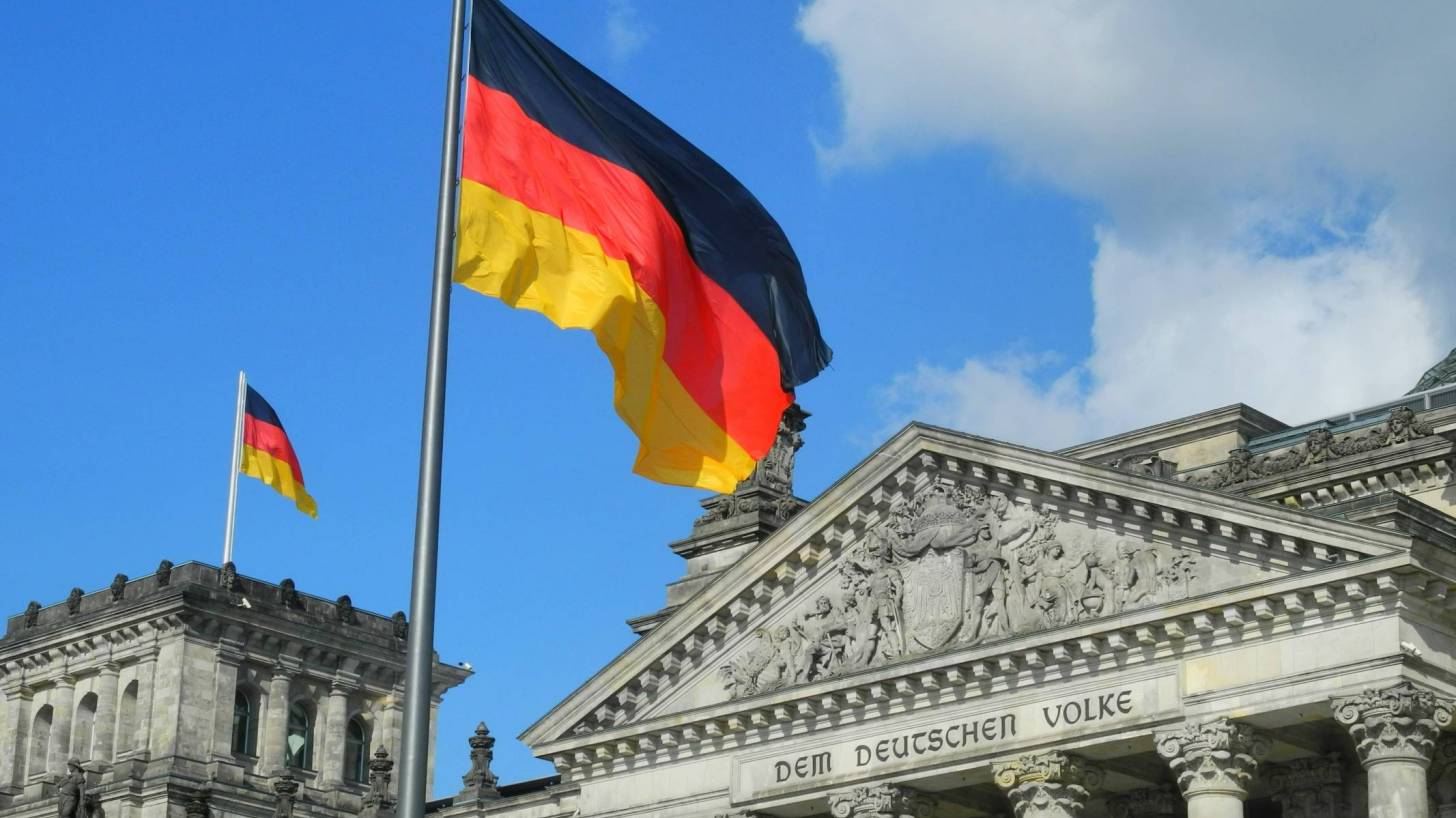 german flag flying over a court building