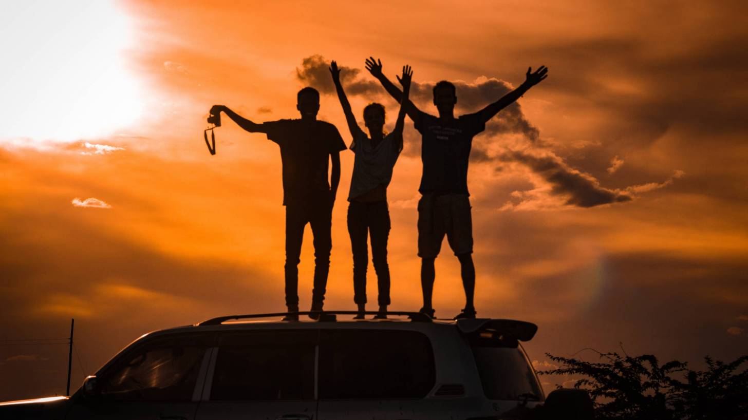 men celebrating on top of ridge