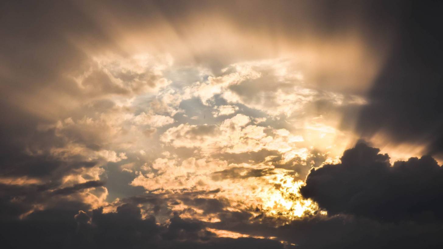 sun breaking through a cloudy sky