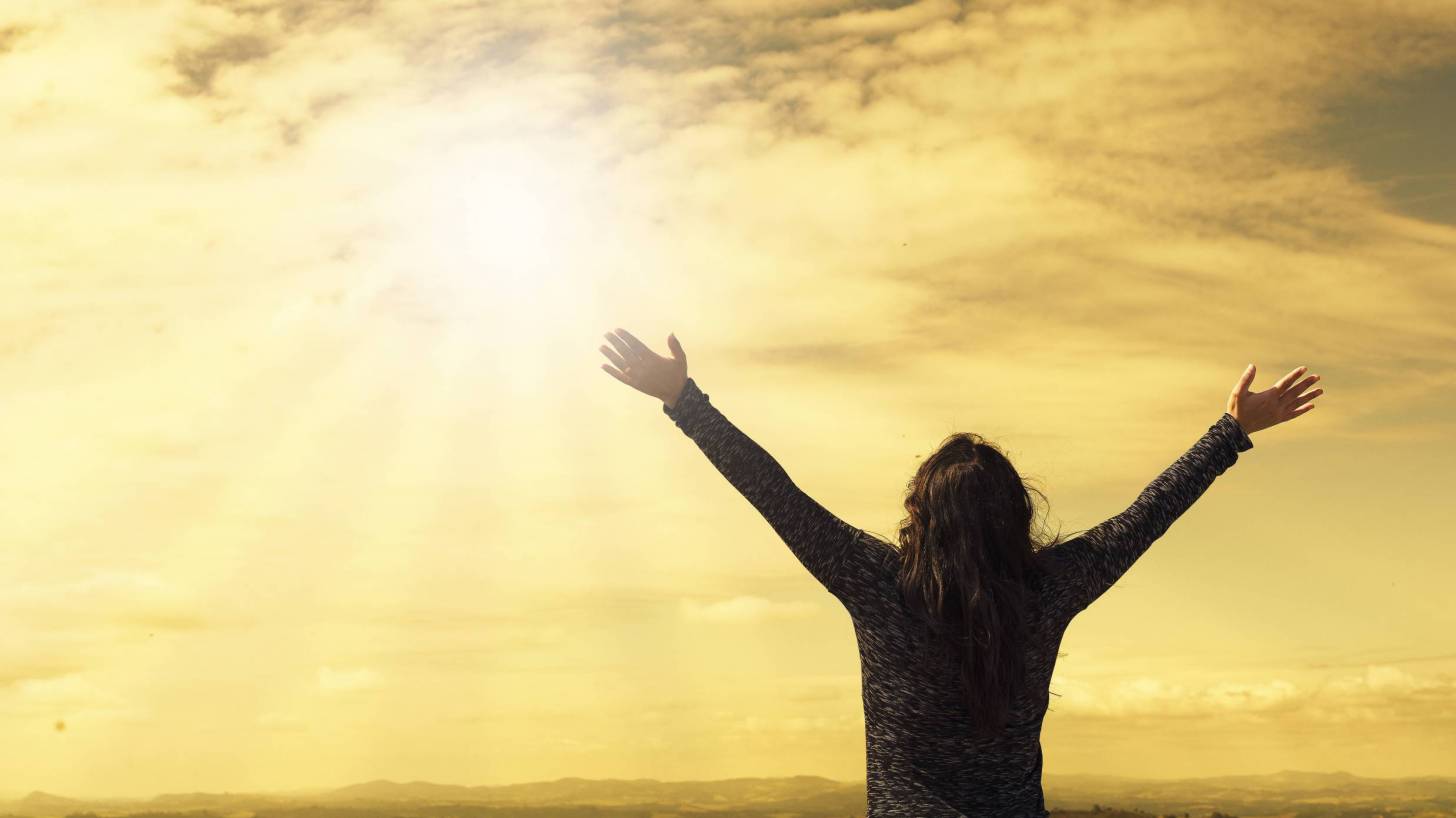 hopeful woman praising the sky