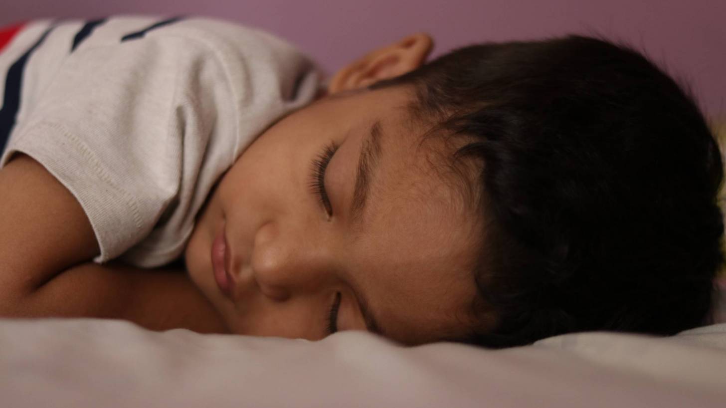 sleeping boy in bed