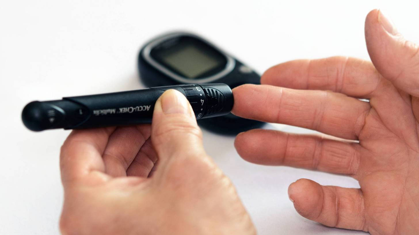 man testing his blood sugar level