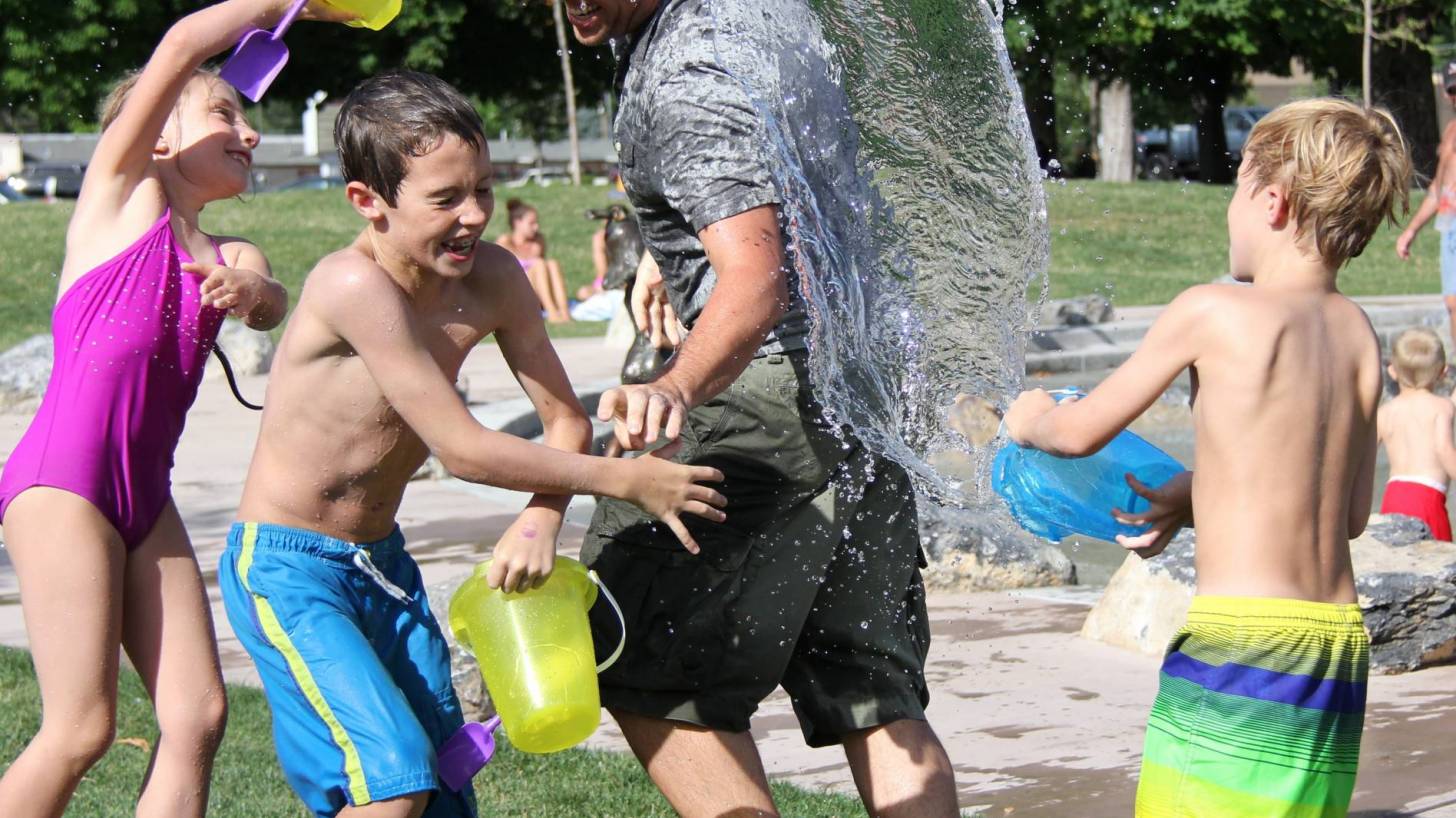 young dad playing with his children boys and girls