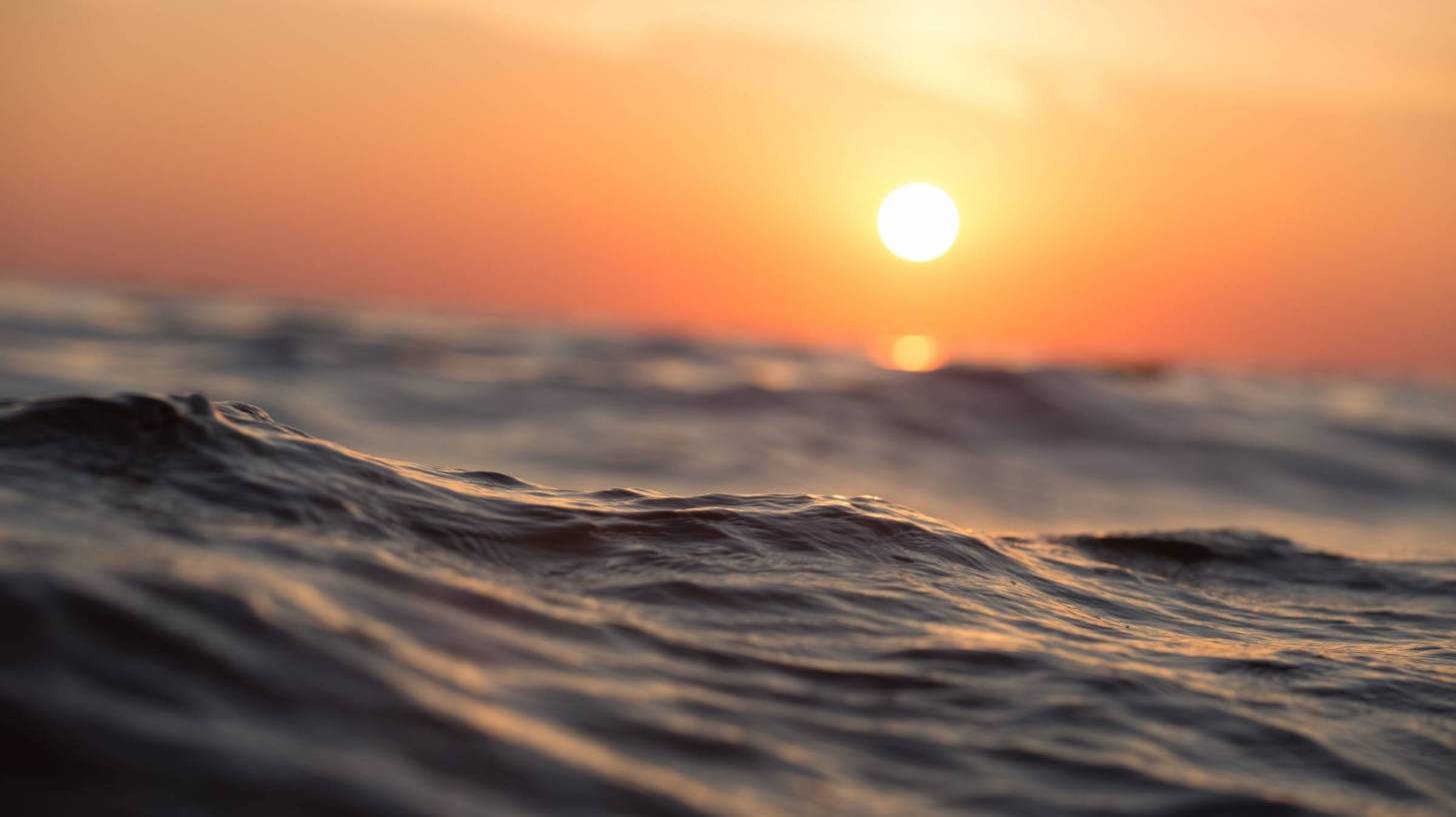 sunrise over the ocean with waves