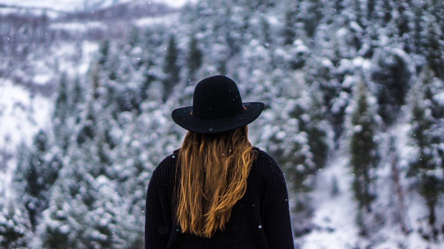 young women sitting in a snowy forest