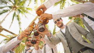 men cheering with beers