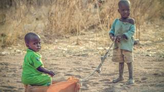 young children in africa playing with a box